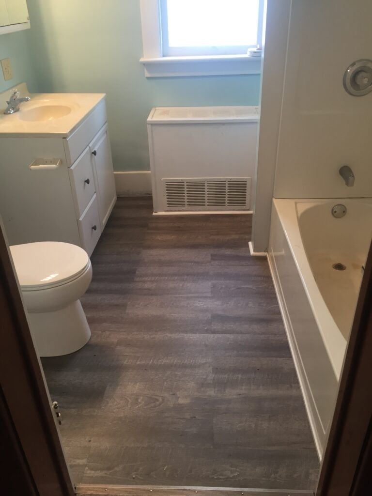 Bathroom remodel Findlay — after: completed bathroom with new flooring, vanity, toilet, and tub, Findlay, Ohio