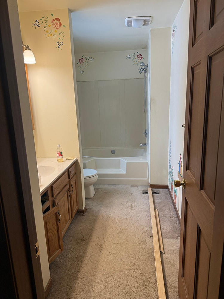 Before: original bathroom with dated tub surround — Findlay, Ohio