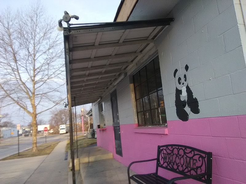 Cedar porch and overhang Findlay — before: old metal awning and pink/grey painted block exterior, Findlay, Ohio