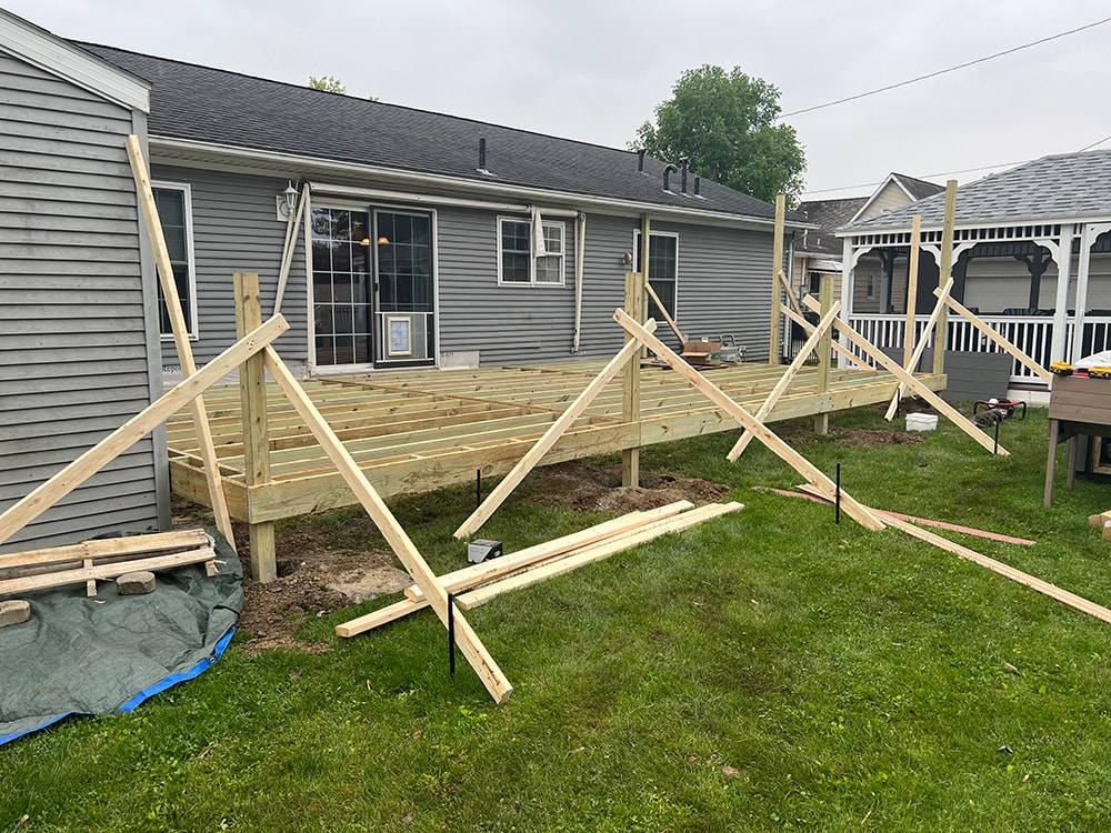 Composite deck — during construction: full deck frame with posts and diagonal bracing installed, roof structure taking shape, Findlay, Ohio