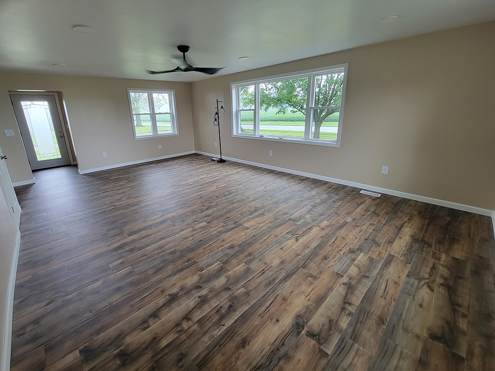 Entire house remodel — after: completed living area with new hardwood flooring and trim — Arlington, Ohio