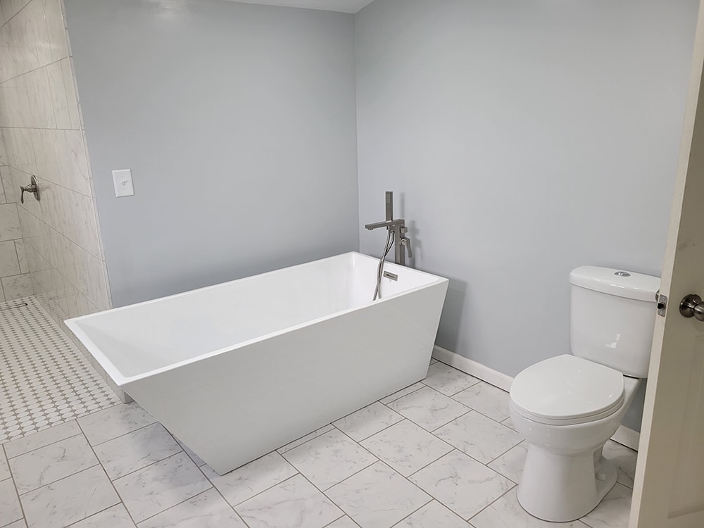 Entire house remodel — after: completed laundry or utility room with new flooring — Arlington, Ohio
