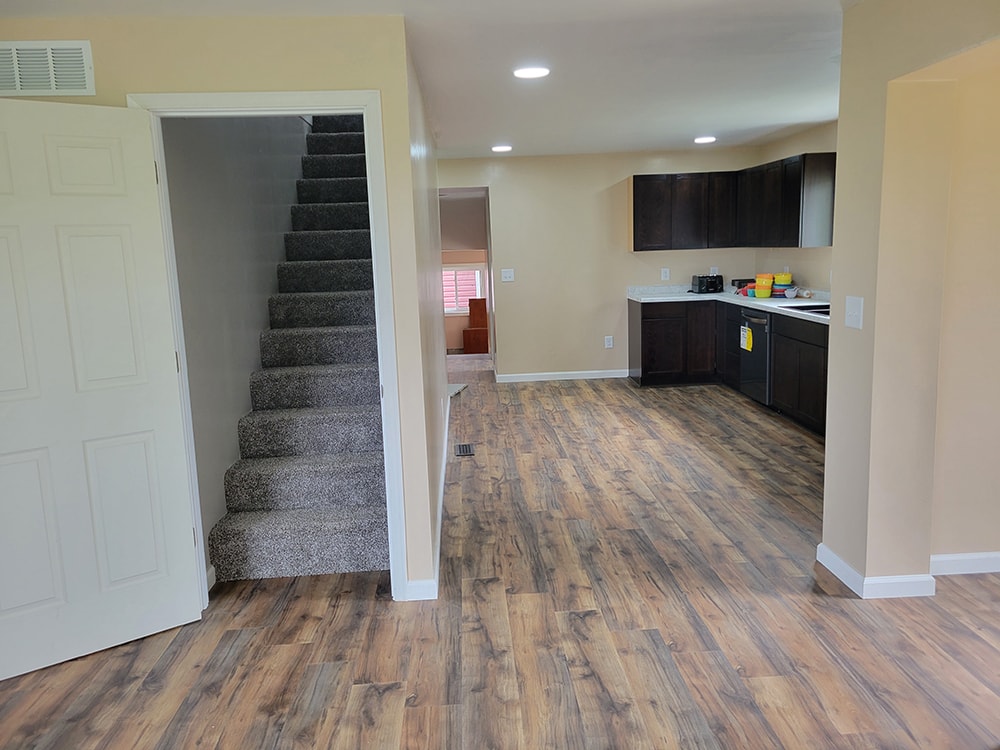 Entire house remodel — after: completed main floor bedroom with new flooring and windows — Arlington, Ohio