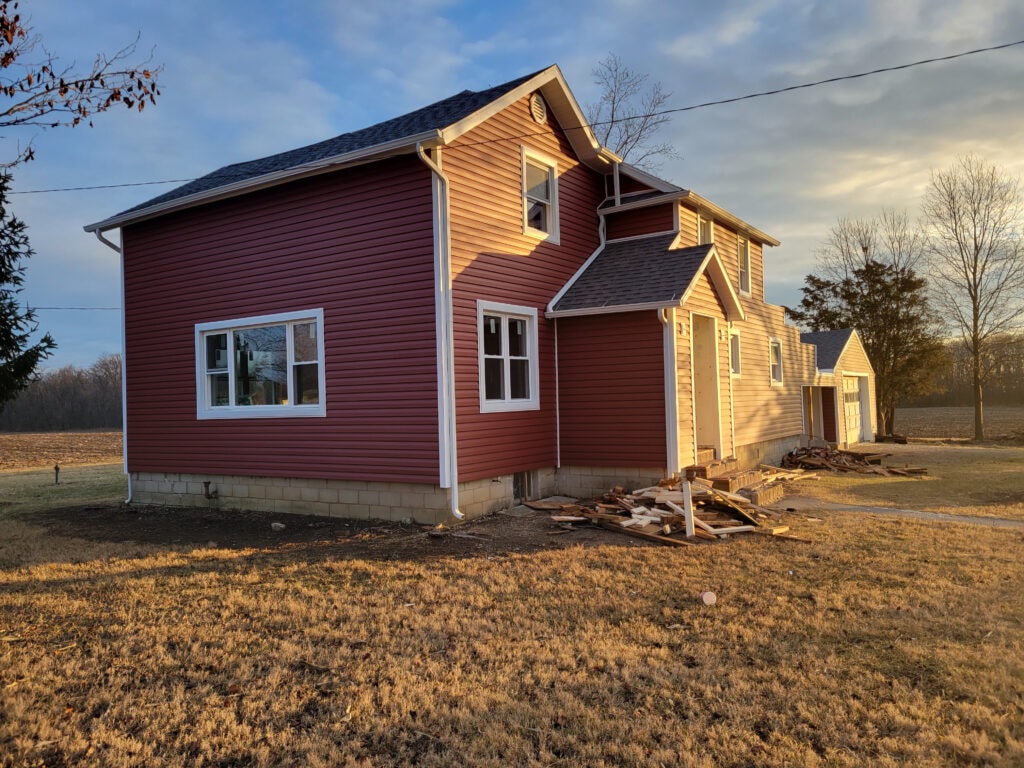 Entire house remodel — after: completed exterior view showing new siding on garage side — Arlington, Ohio