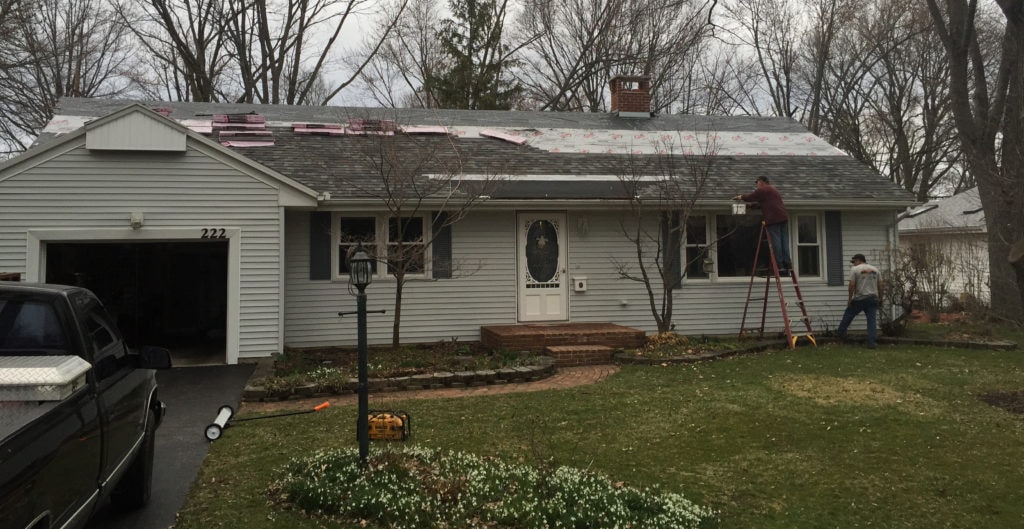Front porch roof addition Findlay — before: roof tear-off in progress with crew on ladders, Findlay, Ohio