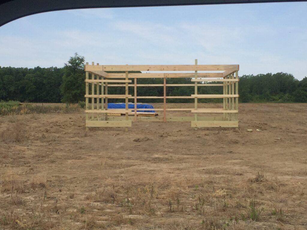 Garage build Arcadia — during: wall framing standing with open stud bays and door rough opening, Arcadia, Ohio