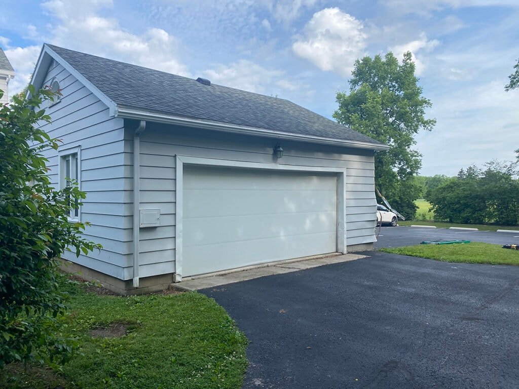 Hancock Park District siding — before: detached garage with original light gray siding and white garage door, Findlay, Ohio