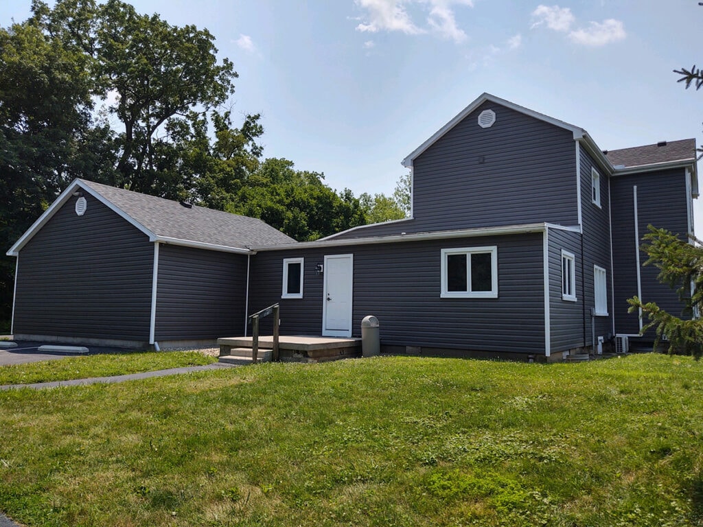 Hancock Park District siding — after: rear of Welcome Center complex with new dark charcoal siding on multiple buildings, Findlay, Ohio