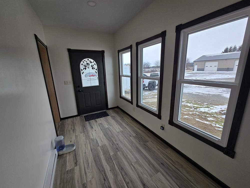 2 additions home remodel — mudroom addition interior with black-framed windows — Findlay, Ohio
