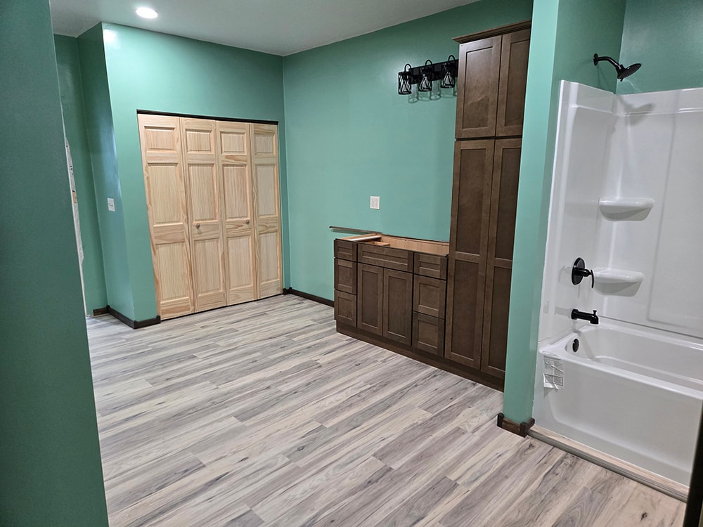 2 additions home remodel — bathroom in progress with cabinets and tub installed — Findlay, Ohio