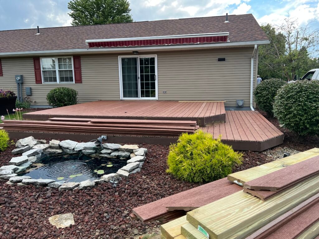 New composite deck — during installation, new composite boards laid with pond and landscaping visible, Fostoria, Ohio
