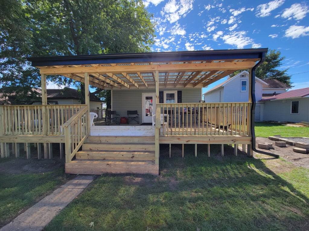 New siding and deck — after, new treated lumber back deck with pergola roof and stairs under construction, Benton Ridge, Ohio