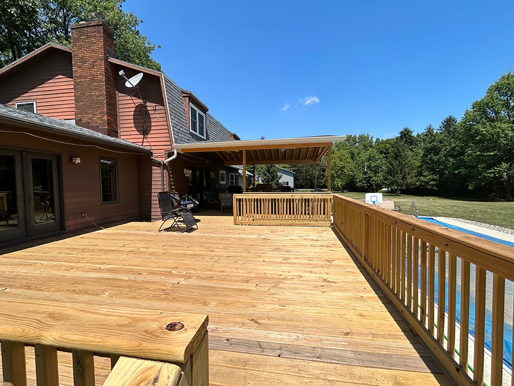 New treated deck with gable — deck surface looking toward covered gable section and pool