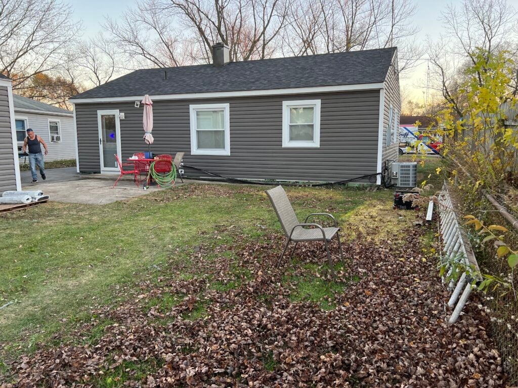 New vinyl siding — house rear after installation with new gray siding, Fostoria, Ohio