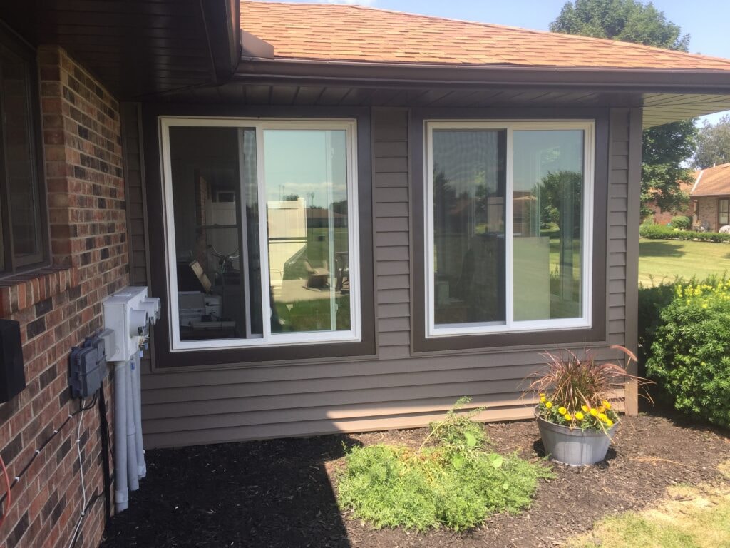 New windows and siding Findlay — close-up of new replacement windows with wrapped trim, Findlay, Ohio