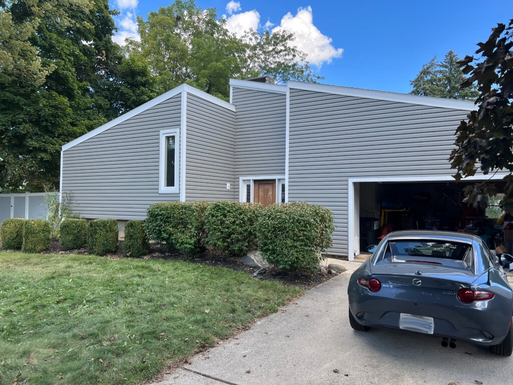 Siding, deck, flooring and stairs — exterior front after, new gray vinyl lap siding with garage door, Findlay, Ohio