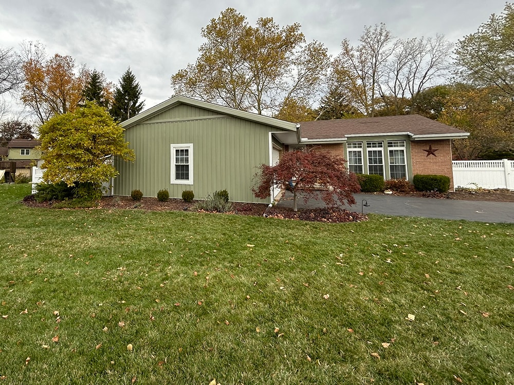 New board and batten siding — front of home with landscaping — Findlay, Ohio