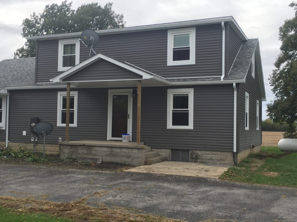 Completed new vinyl siding and replacement windows on farmhouse — Findlay, Ohio