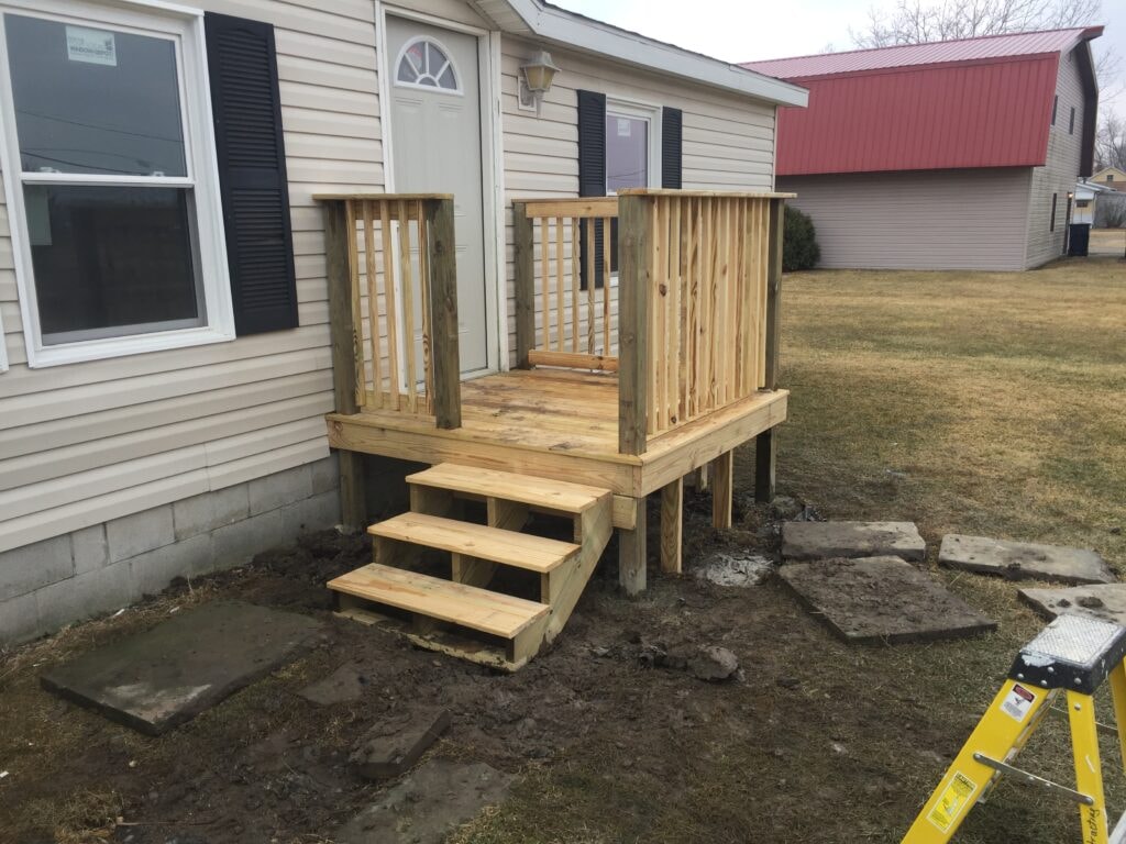 Simple front porch addition Oak Harbor — after: completed deck with steps and railing, Oak Harbor, Ohio