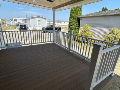 Decking with Cedar tongue and groove ceiling and white aluminum railings